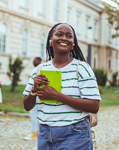 Lachende Frau hält Buch in der Hand