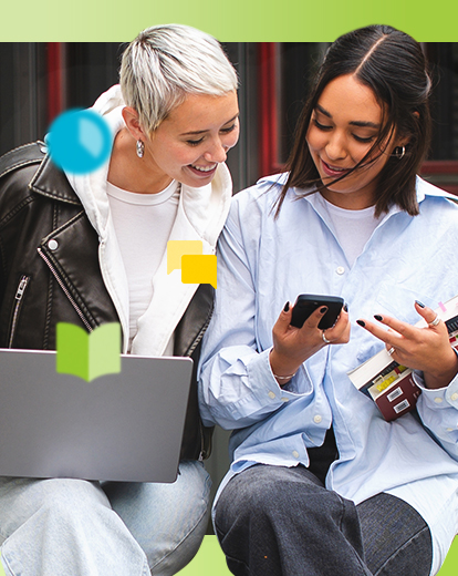 Zwei Studentinnen auf dem Campus sehen sich etwas auf dem Laptop an.